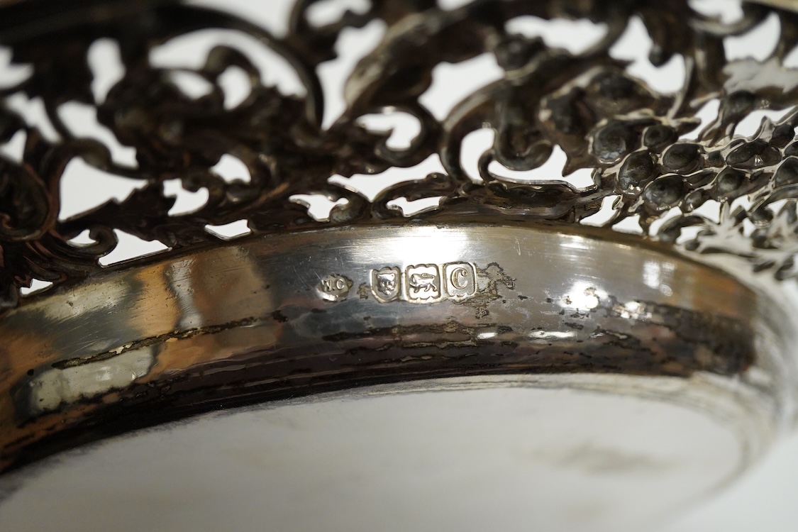 A late Victorian shallow dish or stand, by William Comyns, with pierced foliate border, decorated with masks and birds, London, 1898, diameter 23.1cm, 11.4oz.